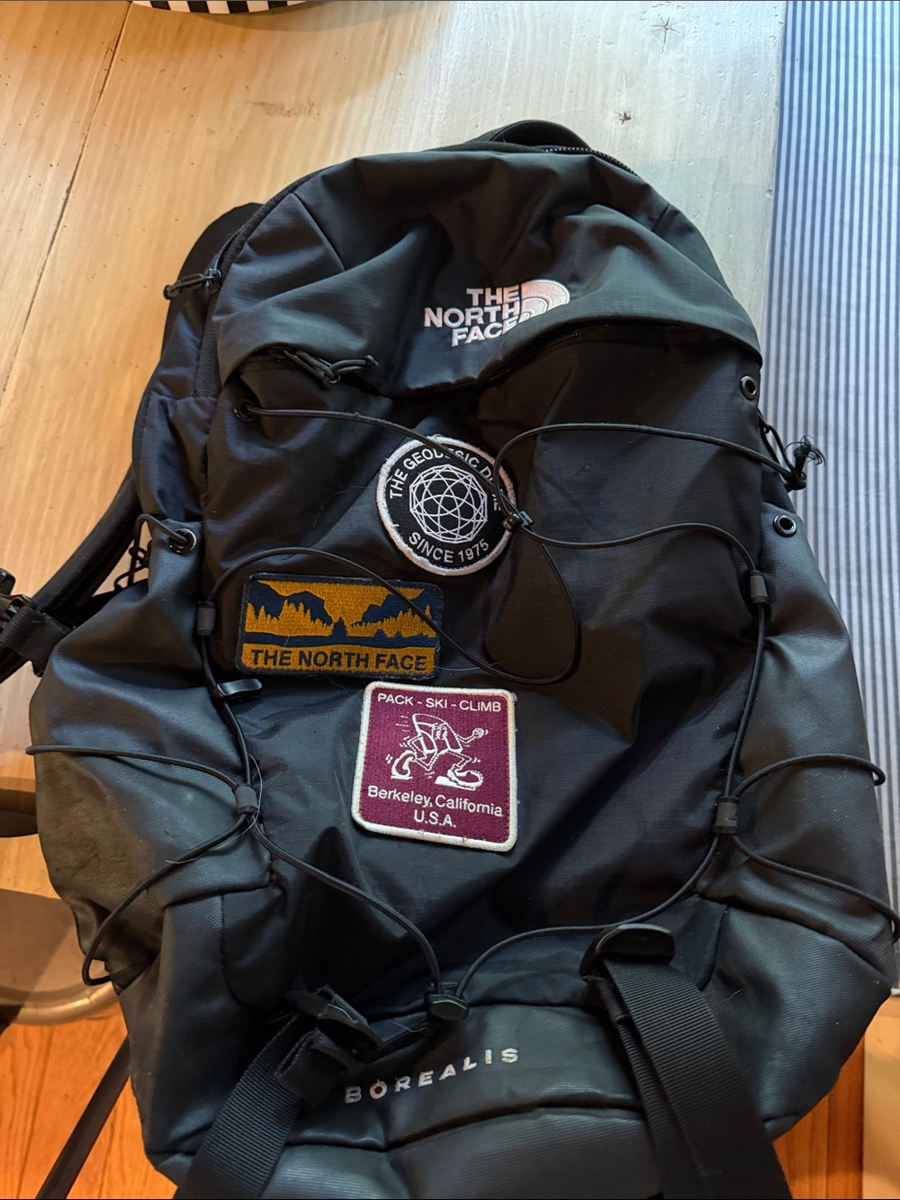 The North Face Black Borealis Backpack with Patch Accents cord is a little brok